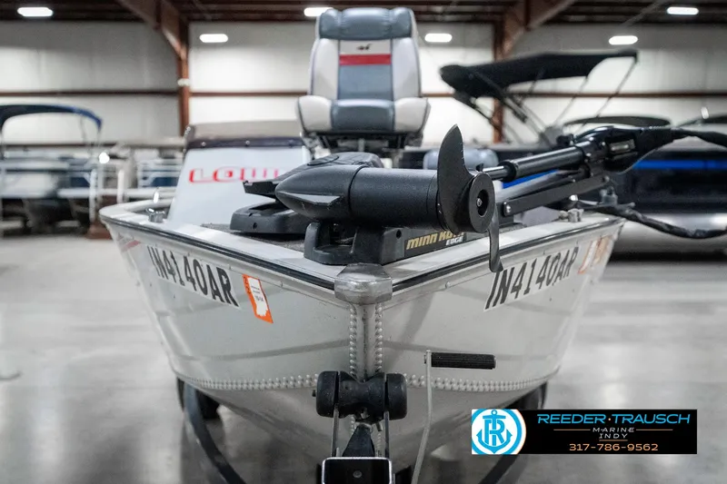 Slide: The Image of 1990 Lowe 1700 boat with trolling motor in indoor showroom. - 3