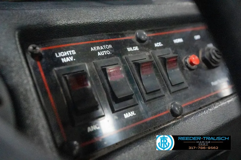 Slide: The Image of Control panel of a 1990 Lowe 1700 boat with various switches and labels. - 32