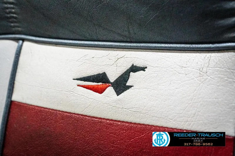 Slide: The Image of Vintage Lowe 1700 boat seat with logo, featuring red, white, and black colors. - 34