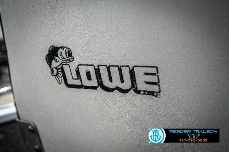 Slide: The Image of Lowe 1700 logo with fish design, 1990 model, Reeder-Trausch branding. - 35