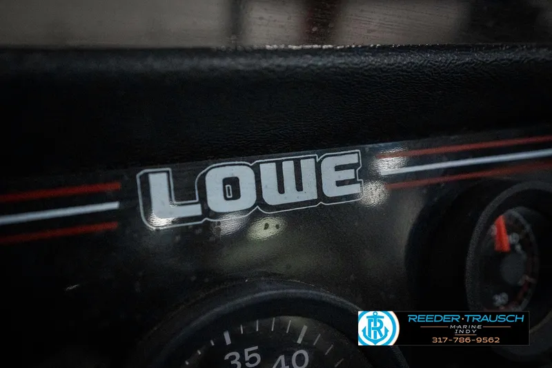 Slide: The Image of Dashboard of a 1990 Lowe 1700 boat with visible gauges and branding. - 36