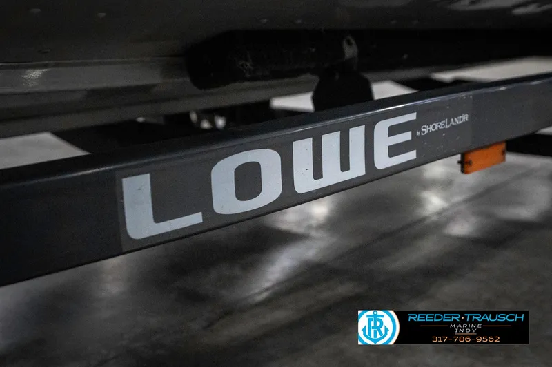 Slide: The Image of Lowe 1700 trailer detail, 1990 model, featuring Shorelander branding in a garage setting. - 45
