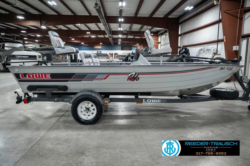 Slide: The Image of 1990 Lowe 1700 boat on trailer in indoor showroom setting. - 5