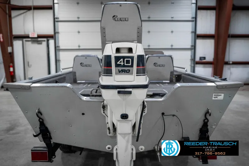 Slide: The Image of 1990 Lowe 1700 boat with 40 VRO outboard motor in a garage setting. - 7