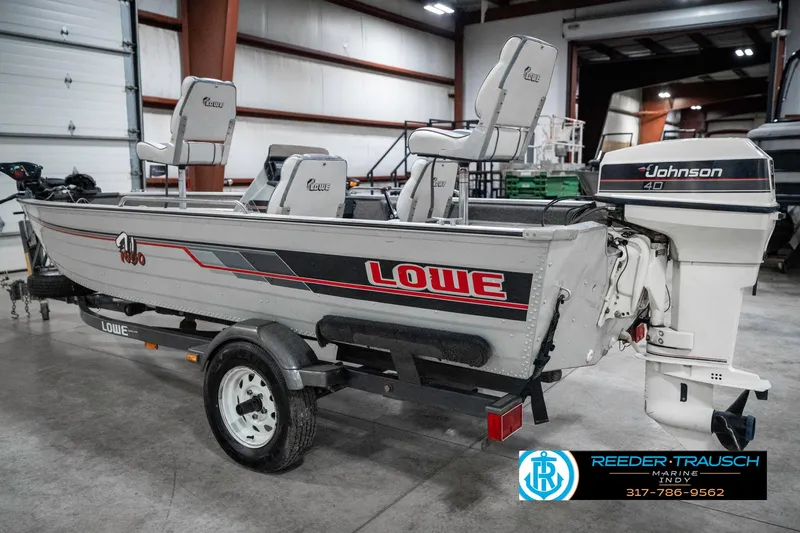 Slide: The Image of 1990 Lowe 1700 boat with Johnson 40 engine in a garage setting. - 8
