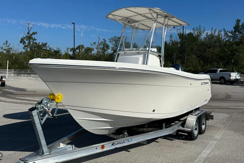 Slide: The Image of 2022 Cobia 201 Center Console boat on trailer in parking lot. - 1