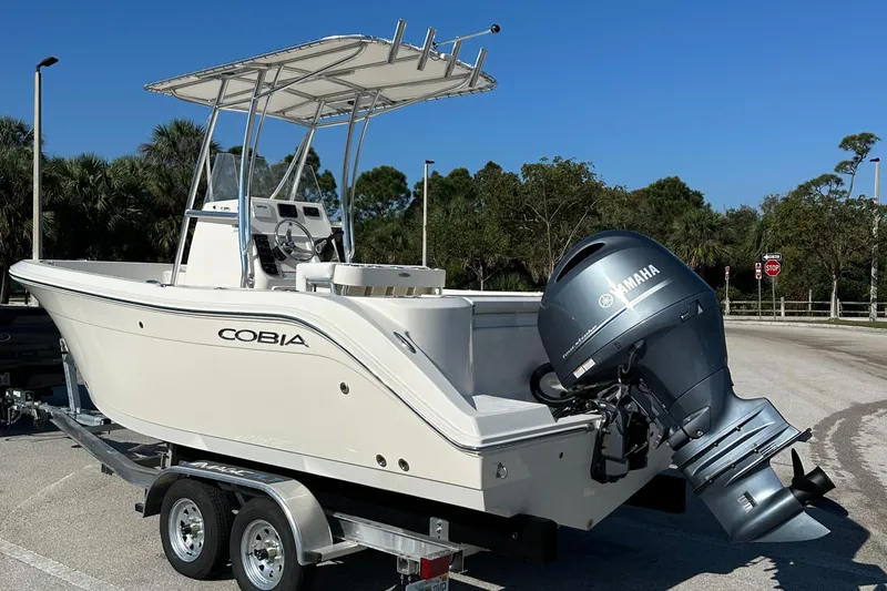 Slide: The Image of 2022 Cobia 201 Center Console boat on trailer with Yamaha outboard motor. - 2