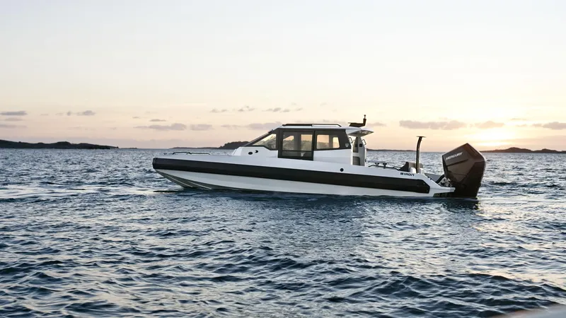 Slide: The Image of 2025 Iron 827C boat cruising on open water at sunset. - 4