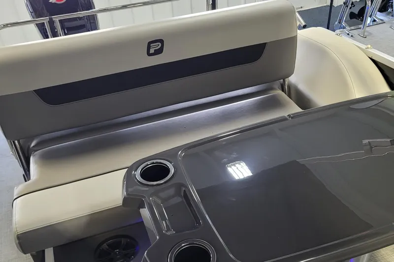 Slide: The Image of 2025 Princecraft Vectra 21 RL boat interior with seating and table featuring cup holders. - 2