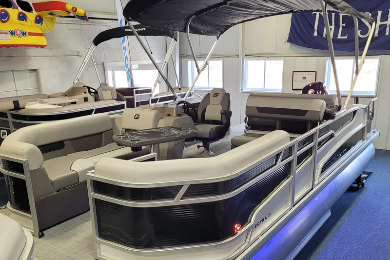 Slide: The Image of 2025 Princecraft Vectra 21 RL pontoon boat with spacious seating and canopy in showroom. - 22