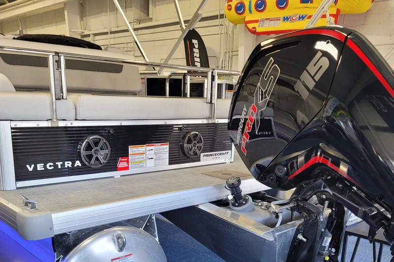 Slide: The Image of 2025 Princecraft Vectra 21 RL pontoon boat with powerful outboard motor in showroom. - 3