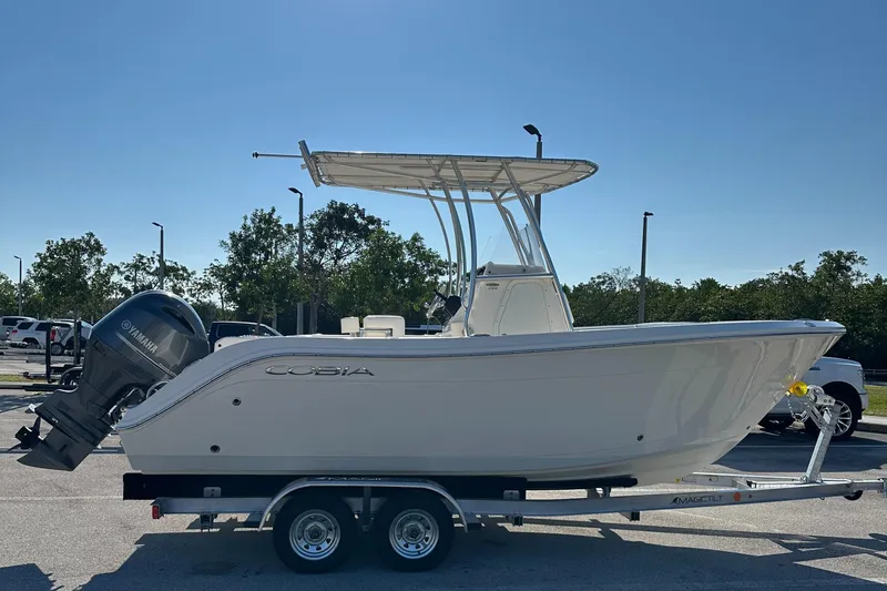 Slide: The Image of 2022 Cobia 201 Center Console boat on trailer, side view. - 1