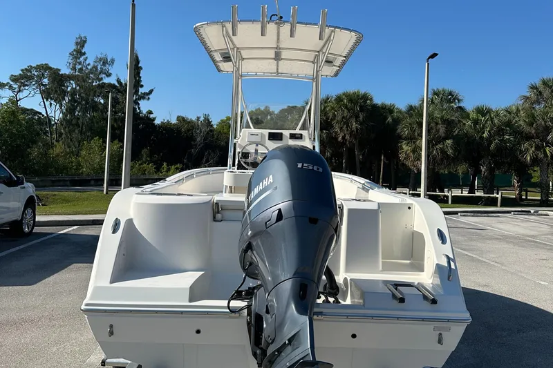 Slide: The Image of 2022 Cobia 201 Center Console boat with Yamaha outboard motor in parking lot. - 3