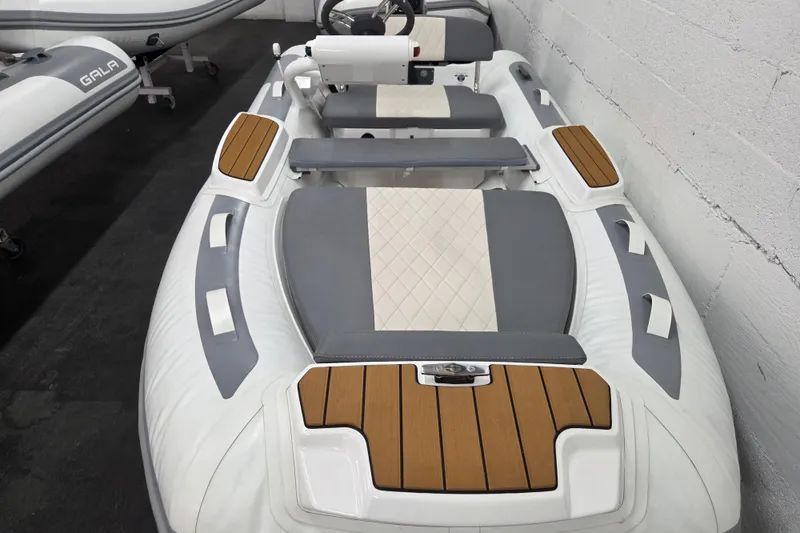 Slide: The Image of 2025 Gala A330HQ ELECTRIC inflatable boat with sleek design and wood accents. - 3