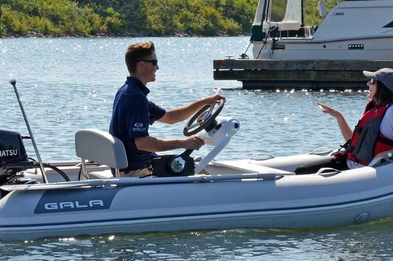 Slide: The Image of Two people enjoying a ride on a 2025 Gala A330HQ ELECTRIC boat. - 7