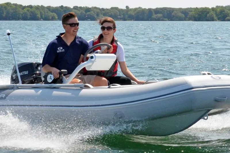 Slide: The Image of Two people enjoying a ride on a 2025 Gala A330HQ ELECTRIC boat on a sunny lake. - 9