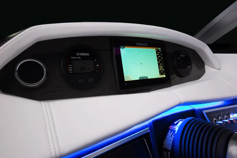 Slide: The Image of 2025 Four Winns HD5 OB dashboard with Simrad display and Yamaha gauges, illuminated in blue. - 10