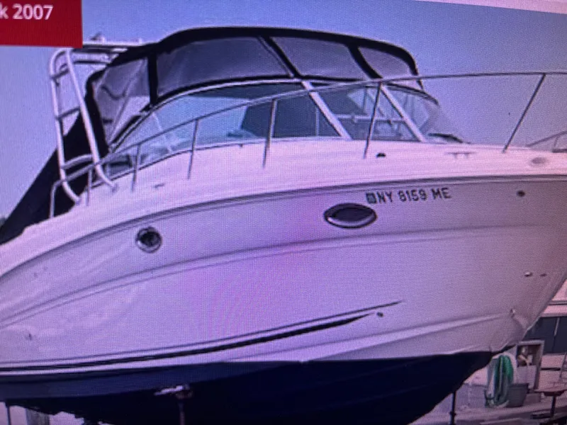 Slide: The Image of 2007 Sea Ray Amberjack boat docked, featuring sleek design and covered cockpit. - 2
