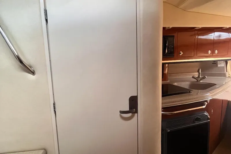 Slide: The Image of Interior of 2007 Sea Ray Amberjack boat showing kitchenette and door. - 29