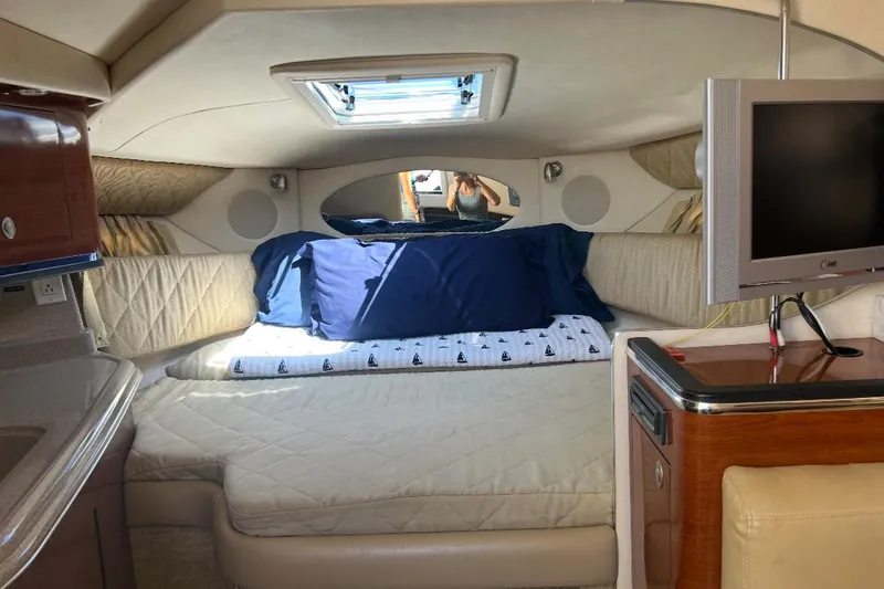 Slide: The Image of 2007 Sea Ray Amberjack cabin interior with bed, TV, and skylight. - 31
