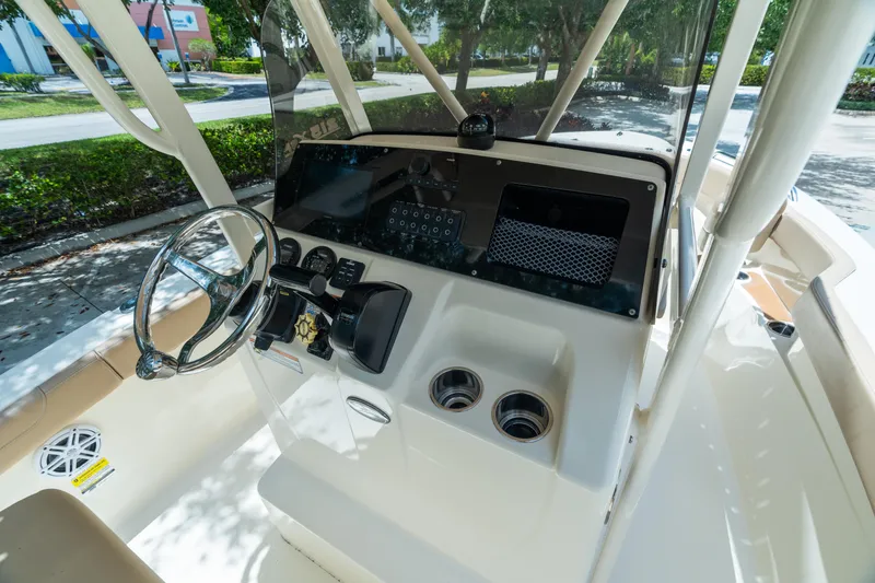Slide: The Image of 2023 Scout 215 XSF boat dashboard with steering wheel and controls. - 7