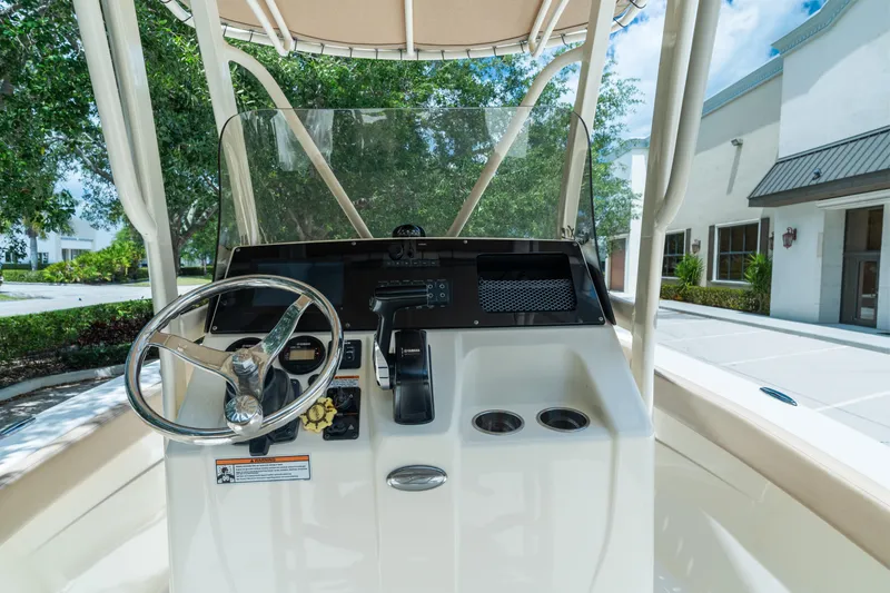 Slide: The Image of 2023 Scout 215 XSF boat console with steering wheel and controls. - 8