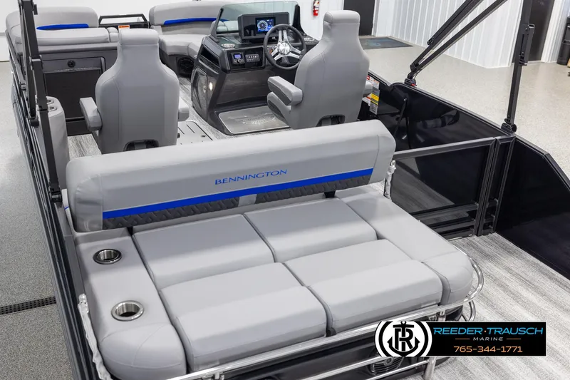 Slide: The Image of 2025 Bennington 22 MSBSE pontoon boat interior with gray seating and modern dashboard. - 11
