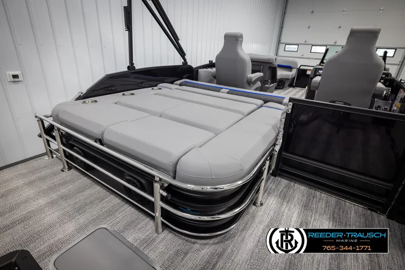 Slide: The Image of 2025 Bennington 22 MSBSE pontoon boat interior with gray seating in a showroom. - 29