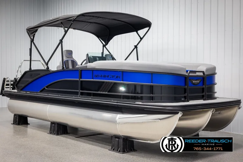 Slide: The Image of 2025 Bennington 22 MSBSE pontoon boat with blue and black accents, displayed indoors. - 3
