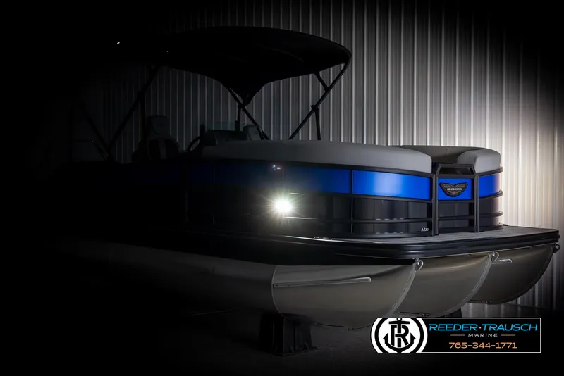 Slide: The Image of 2025 Bennington 22 MSBSE pontoon boat in dimly lit showroom. - 4