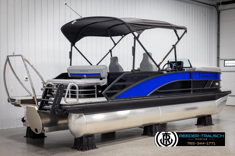 Slide: The Image of 2025 Bennington 22 MSBSE pontoon boat with blue accents in a showroom. - 6