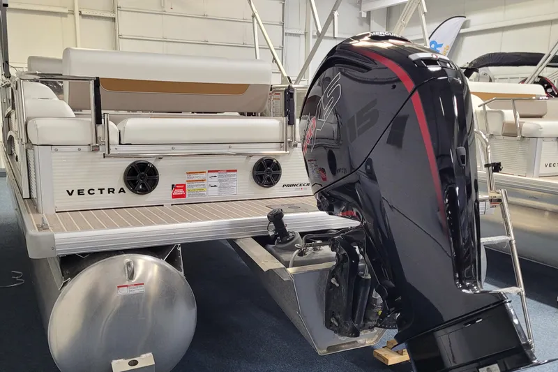 Slide: The Image of 2025 Princecraft Vectra 21 RL pontoon boat with powerful outboard motor in showroom. - 10