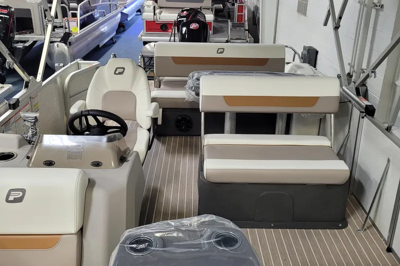 Slide: The Image of 2025 Princecraft Vectra 21 RL pontoon boat interior with seating and steering console. - 2