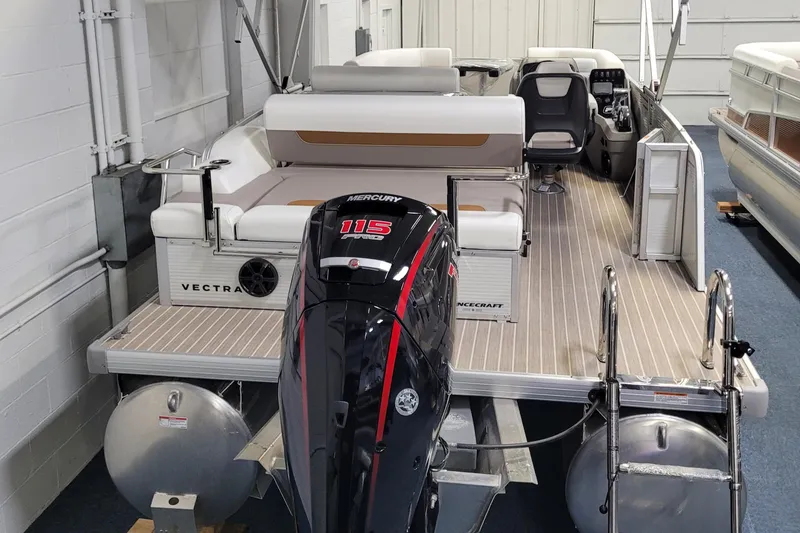 Slide: The Image of 2025 Princecraft Vectra 21 RL pontoon boat with Mercury 115 engine in showroom. - 9