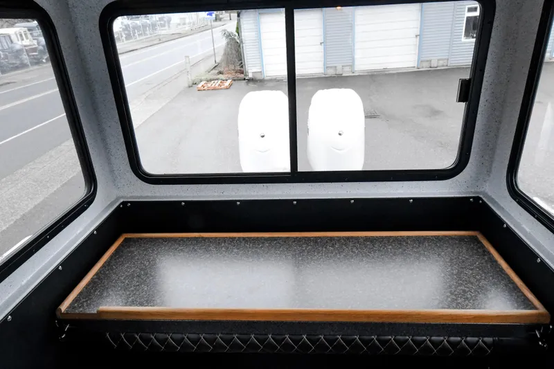 Slide: The Image of Interior view of a 2025 Custom 24 LC vehicle with a countertop and large windows. - 10