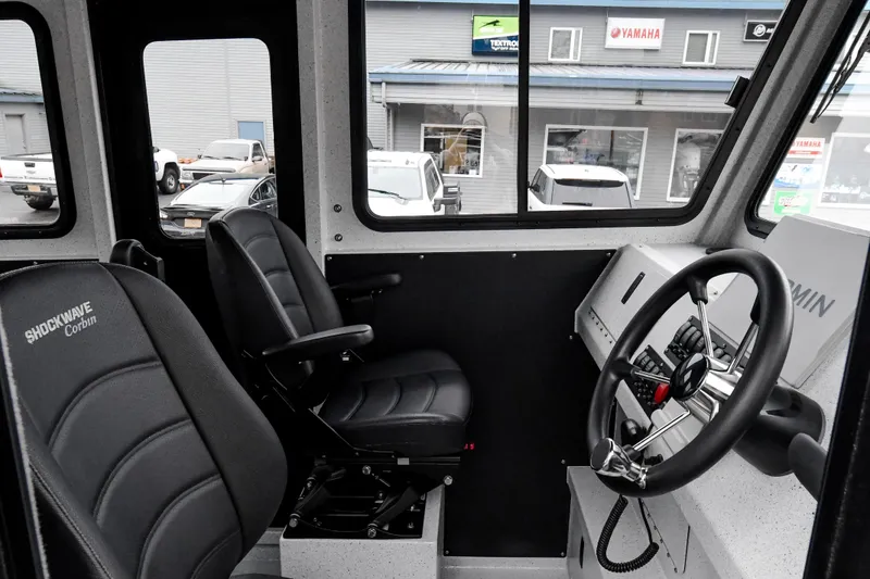 Slide: The Image of Interior of 2025 Custom 24 LC boat with steering wheel and seats. - 7