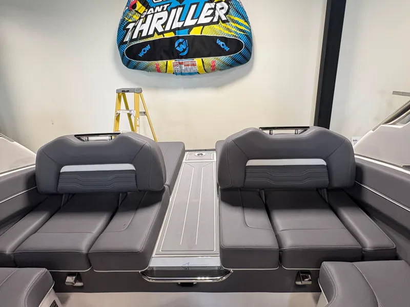 Slide: The Image of 2025 Regal LS6 boat interior with gray seating and a colorful inflatable tube. - 12