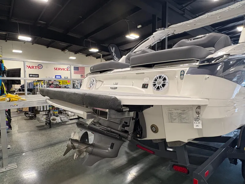 Slide: The Image of 2025 Regal LS6 boat in showroom, showcasing rear design and propeller. - 17