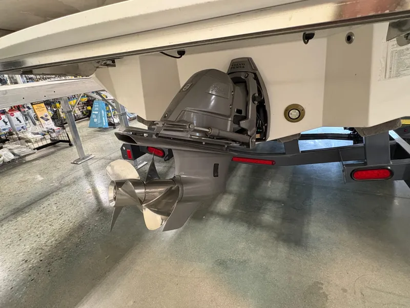 Slide: The Image of 2025 Regal LS6 boat with outboard motor and propeller on display in showroom. - 19