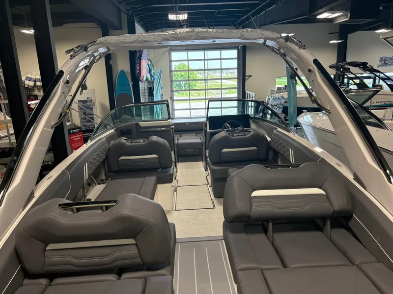 Slide: The Image of 2025 Regal LS6 boat interior with luxurious seating and modern design in showroom. - 2