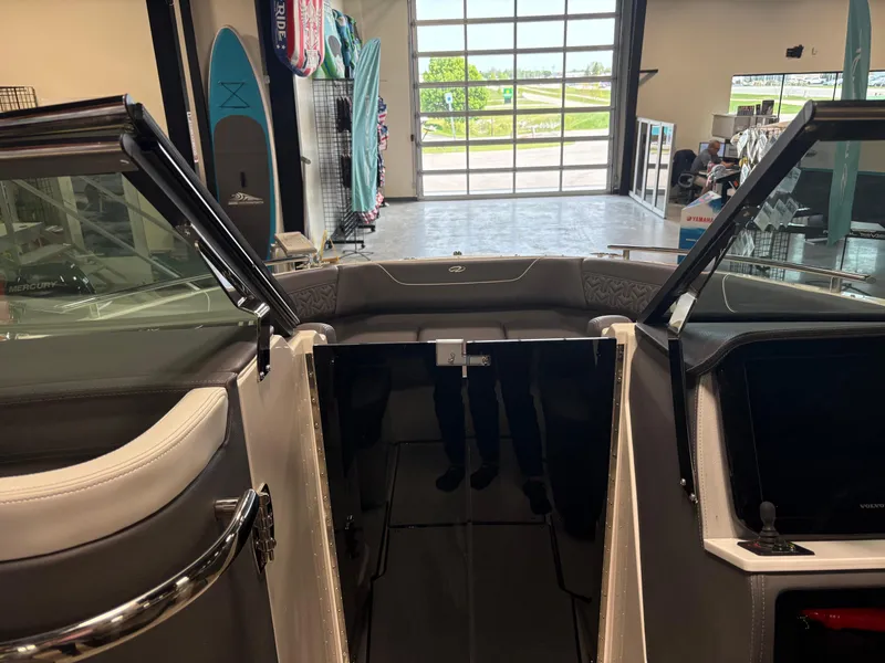 Slide: The Image of 2025 Regal LS6 boat interior with open cabin door in showroom setting. - 5