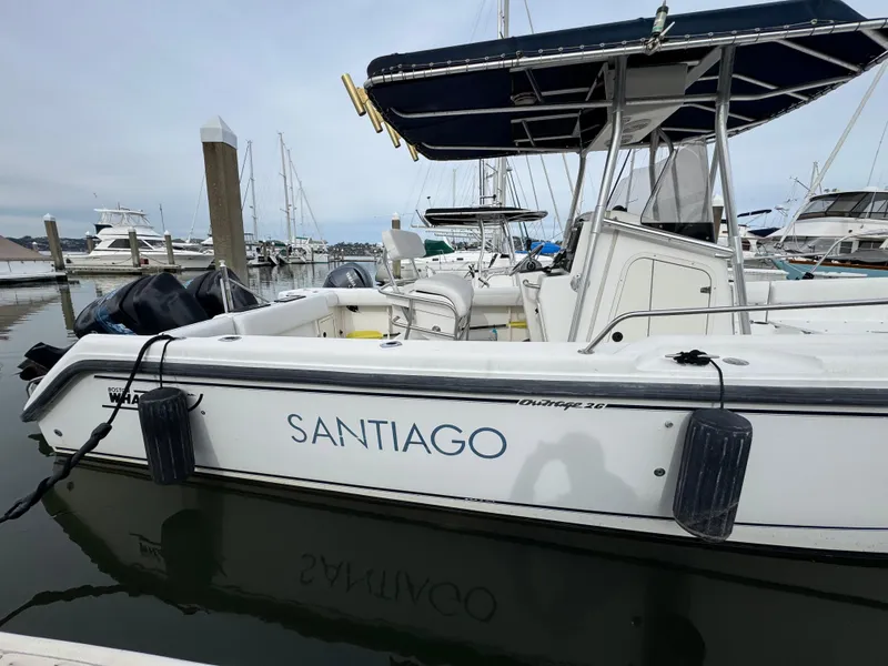 Slide: The Image of 2001 Boston Whaler 26 Outrage boat named "Santiago" docked in a marina. - 12