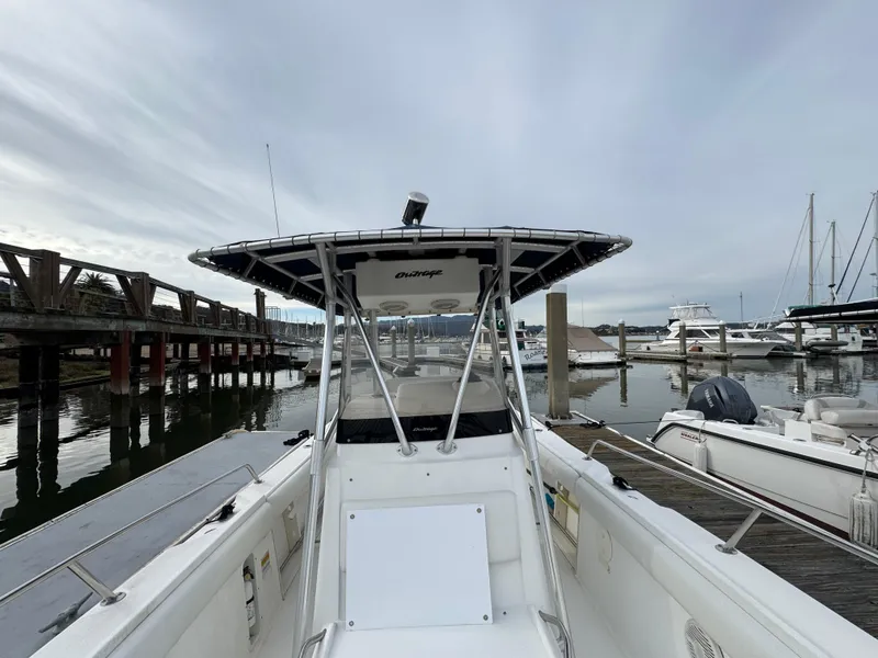 Slide: The Image of 2001 Boston Whaler 26 Outrage boat docked at marina, overcast sky, calm waters. - 13