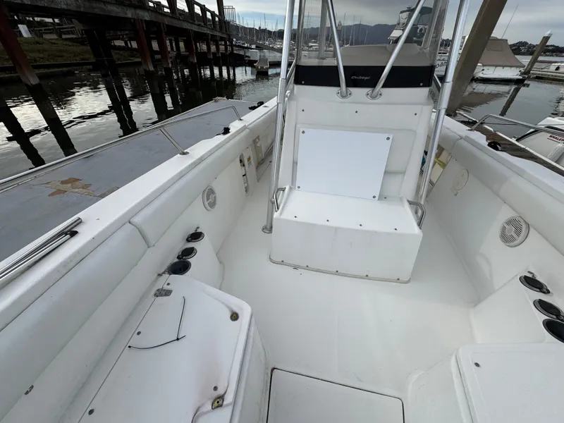 Slide: The Image of 2001 Boston Whaler 26 Outrage boat interior, featuring spacious seating and storage areas. - 14