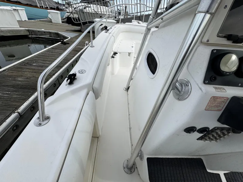 Slide: The Image of 2001 Boston Whaler 26 Outrage boat interior with stainless steel railings and control panel. - 16