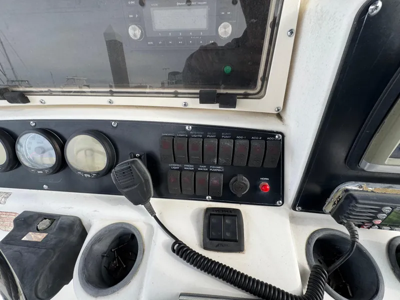 Slide: The Image of Control panel of a 2001 Boston Whaler 26 Outrage boat with switches and gauges. - 17