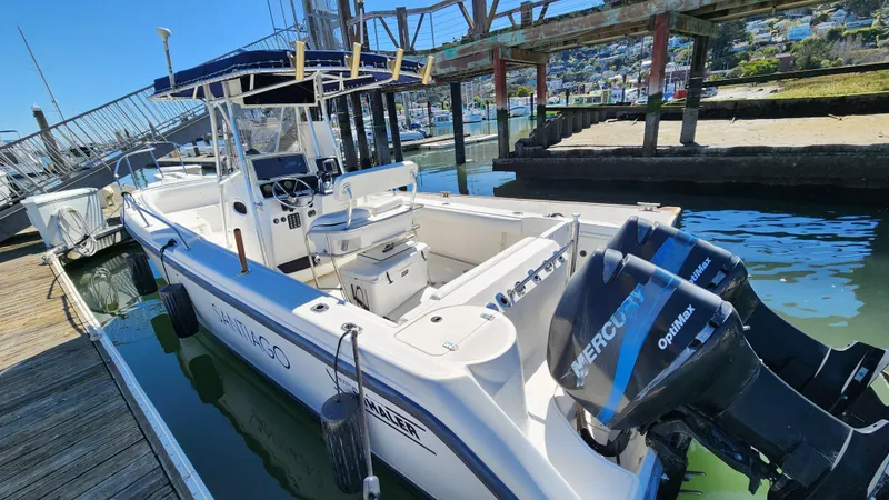 Slide: The Image of 2001 Boston Whaler 26 Outrage boat docked with twin Mercury engines. - 2