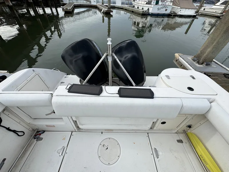 Slide: The Image of 2001 Boston Whaler 26 Outrage boat interior with dual engines at dock. - 21