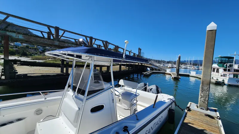 Slide: The Image of Boston Whaler 26 Outrage 2001 docked at marina under clear blue sky. - 4
