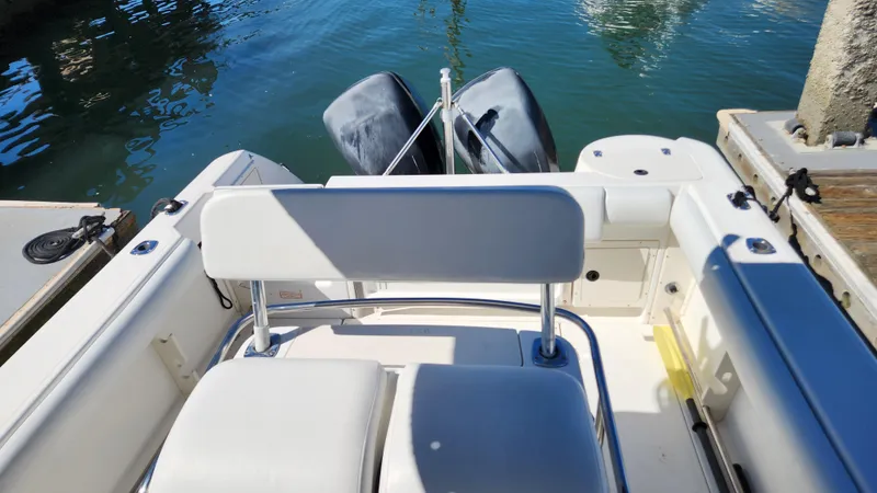Slide: The Image of 2001 Boston Whaler 26 Outrage boat interior with dual outboard motors at dock. - 5